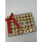 Box of Ferrero Rocher chocolates tied with a red ribbon