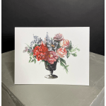 Floral arrangement in a black vase with red, pink, and purple blooms
