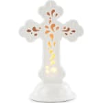 White decorative cross-shaped candle holder with orange cutout accents