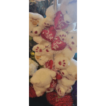 Stack of white teddy bears holding red heart pillows with "Love You" text
