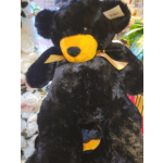 Black teddy bear with a yellow snout and ribbon