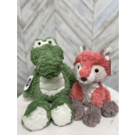 Two plush animal toys, a green crocodile and a pink fox, sit side by side.