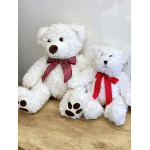 Two white teddy bears with red ribbons sitting side by side