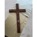 Wooden cross on a satin cloth background