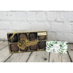 Box of assorted chocolates with a gift card beside it
