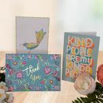 Greeting cards with floral designs and a "Kind People" message