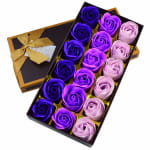 Box of purple and pink roses in a gift box with a gold ribbon
