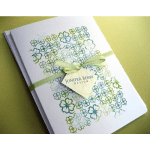 White gift box with green floral pattern and ribbon
