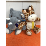 Two plush animals, an elephant and a giraffe, sit side by side.