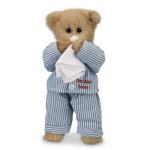 Teddy bear in striped pajamas holding a tissue