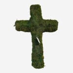 Moss-covered cross-shaped form with a small white tag attached