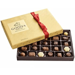 Box of assorted chocolates with a gold lid and red ribbon