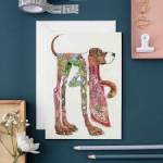 Decorative dog illustration on a card with stationery around it