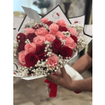 Bouquet of pink and red roses with baby's breath in white wrap