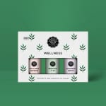 Boxed set of three wellness essential oil bottles on a green background