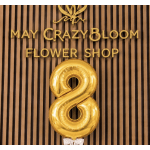 Gold number 8 balloon in front of a flower shop sign