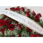 Red rose arrangement with white filler flowers and a personalized message ribbon