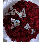 Round bouquet of deep red roses with decorative butterfly picks