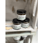 Three jars of vanilla mint lip scrub stacked on a shelf