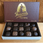 Open box of assorted chocolates in a branded gift box