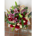 Bouquet of red and cream roses with pink lilies