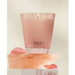 Pink Nest New York candle in a translucent holder with rose petals