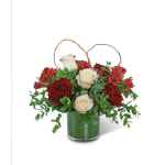 Red and white roses in a glass vase with looped twig handles