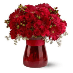 Red flower bouquet in a red glass vase