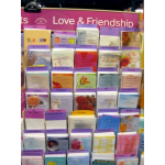 Display rack of greeting cards with a pink "Love & Friendship" sign