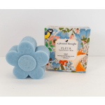 Blue flower-shaped soap beside a floral-patterned box