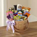 Basket of assorted tea and snack packages with a lavender ribbon