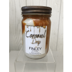 Caramel drip candle in a glass jar with a dark lid