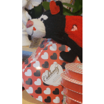 Heart-patterned chocolate gift set with a plush dog and round tins