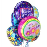 Cluster of colorful birthday balloons with one reading Happy Anniversary