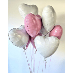 Cluster of heart-shaped pink and white balloons with ribbons