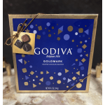 Box of Godiva assorted chocolates tied with a gold ribbon