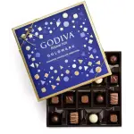 Box of assorted chocolates with a blue lid and gold trim