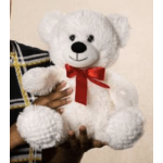 White teddy bear with a red ribbon bow