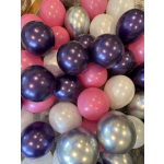 Cluster of pink, purple, white, and silver balloons on the floor