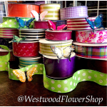 Stacked decorative ribbon spools with butterfly picks