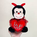 Plush ladybug holding a red heart with the word LOVE