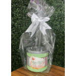 Gift bag with a Bath & Body Works candle tied with a white ribbon