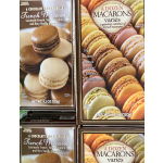 Boxes of assorted French macarons stacked on a shelf