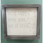 Framed wall sign with the words "being happy never goes out of style"