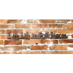 Metal wall sign reading "Live Life in Full Bloom" on a brick wall