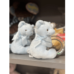 Two light blue teddy bears with ribbons on a shelf