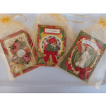 Three Christmas greeting cards in sheer gift bags with ribbon bows