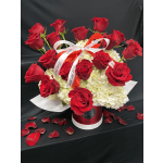 Red roses arranged in a red hatbox with white hydrangeas and ribbon