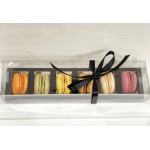 Box of colorful macarons tied with a black ribbon