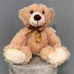 Plush teddy bear with a brown ribbon bow